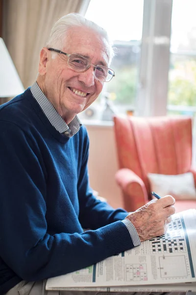 Portrait Of Senior Man Doing Crossword Puzzle At Home — Stock Photo, Image
