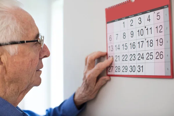 Homem Sênior Confuso com Demência Olhando para a Parede Calendário — Fotografia de Stock