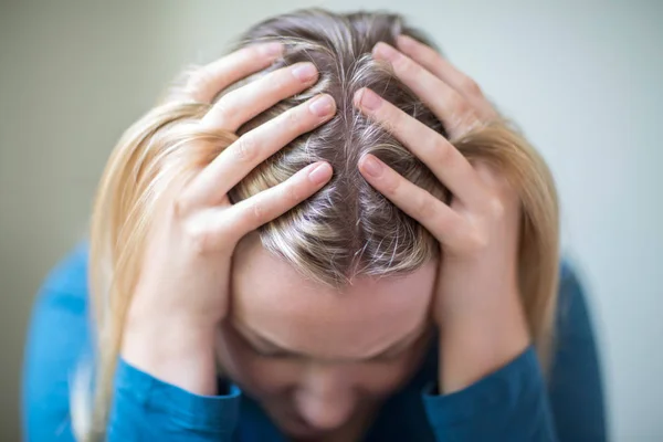 Молодая женщина страдает от депрессии с головой в руках — стоковое фото