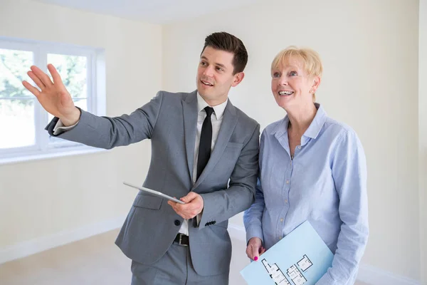 Realtor Avec Tablette Numérique Montrant Femme Âgée Qui Cherche Réduire — Photo