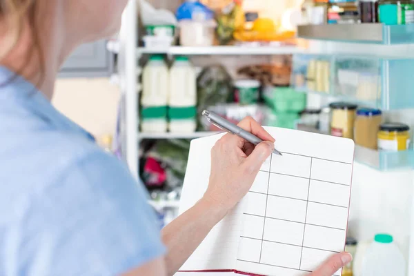 Woman Standing Front Refrigerator Kitchen Notebook Writing Weekly Meal Plan — Stock Photo, Image