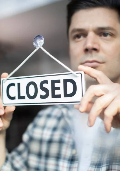 Male Small Business Owner Serious Expression Putting Closed Sign Recession — Stock Photo, Image