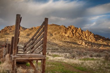 Wooden cattle loading ramp sits on the shady side of the hills