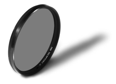 Close up of a circular polarizer filter against the white and ob