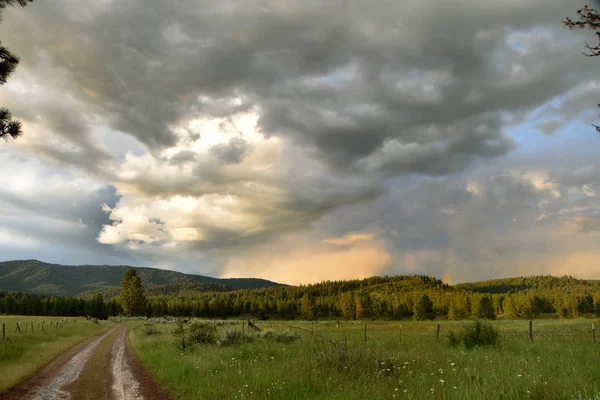 Dirt Road towards the Breaking Clouds — Stock fotografie