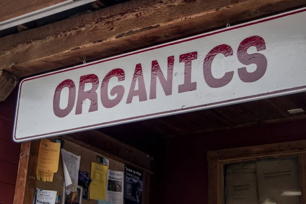 Red White Organics Sign Hanging Wooded Rafter Local Business — Stock Photo, Image