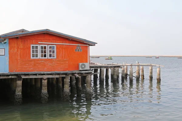 Traditional wooden house of fisherman in orange built on concret stilts — Stock Photo, Image