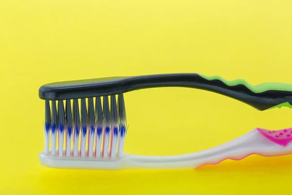 Brand new toothbrush with slim tip bristles on yellow background — Stock Photo, Image