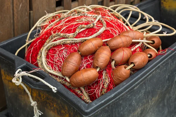 Plastic box full of red white fishing net, huge floats, nylon rope used in fishing industry — Stock Photo, Image