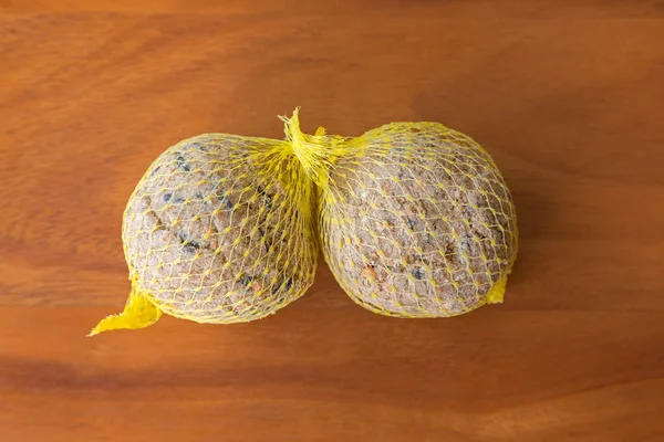 Suet treats, bird food in meshed bag full of nuts sunflower seeds — Stock Photo, Image