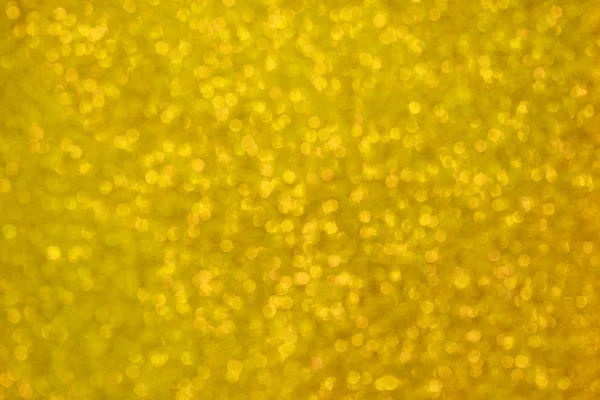 Θολή glittery υφή γκλίτερ σε χρυσοκίτρινο. Αφηρημένα φόντο Bokeh — Φωτογραφία Αρχείου