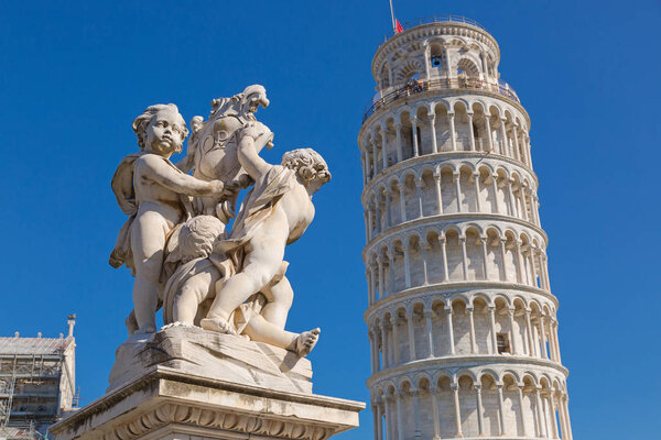 Leaning Tower of Pisa and status of cherubs winged angels in Pisa, Italy