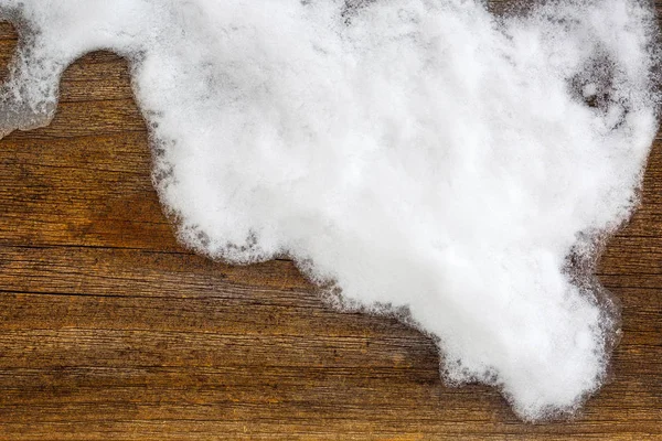 Snowflake, ice crystals on brown wooden background with copyspace — Stock Photo, Image