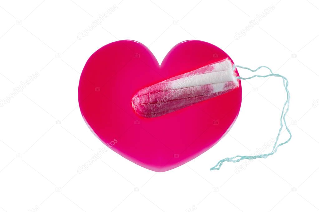 New unused tampon on heart shaped red syrup liquid that looks like blood