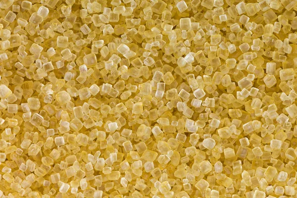 Macro de açúcar cristalino cru não refinado em castanho cristalino — Fotografia de Stock