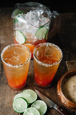 Brunch Micheladas in tall glasses with salted rim clipart