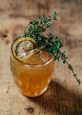 Specialty bourbon cocktail with torched thyme 
