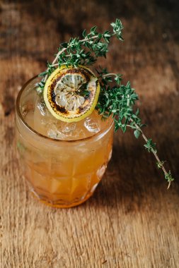 Specialty bourbon cocktail with torched thyme 