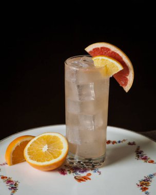 Bir dilim kan portakalıyla süslenmiş alkol kokteyli. 
