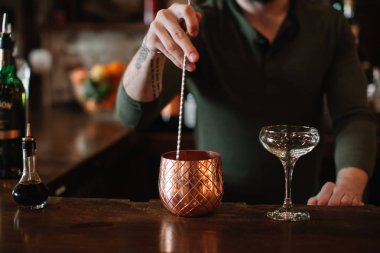 Mixologist creating a cocktail at a bar 