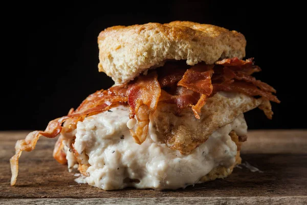 Buttermilk biscuit and fried chicken breast sandwich with a fried egg and bacon — Stock Photo, Image