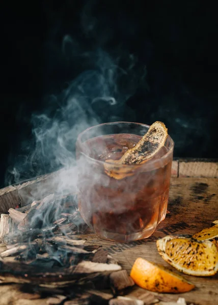 Smoked old fashioned cocktail on dark wooden background — Stock Photo, Image
