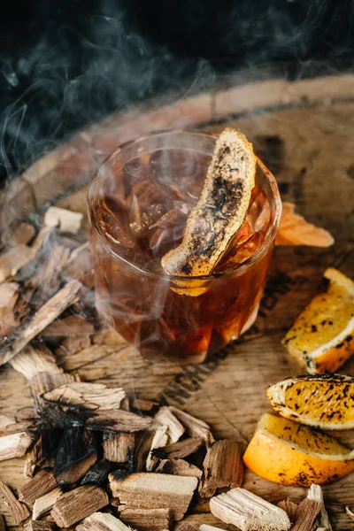 Smoked old fashioned cocktail on dark wooden background — Stock Photo, Image