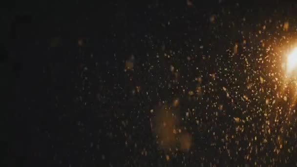 Snowfall against the night sky in the light from a pillar — Stok video