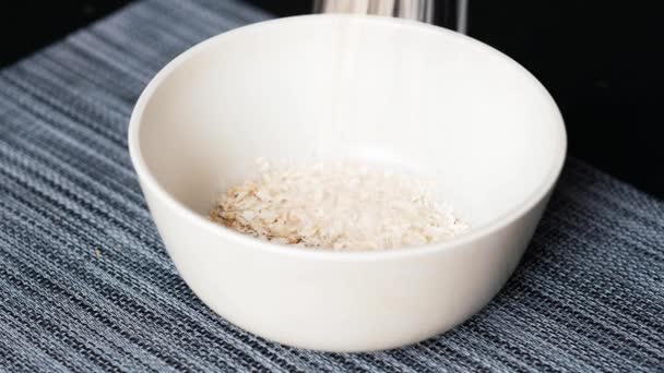 Making breakfast oatmeal with milk — Stock Video