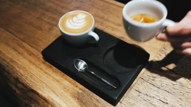 Barista hands coffee to a waitress