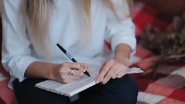 Calligrapher Young Woman writes phrase on white paper — 图库视频影像