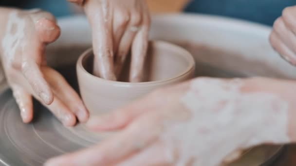 Master teaching a little girl the art of pottery. close-up — Stock Video