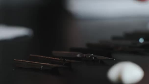 Girl shaves peo for calligraphy on a black table close-up — ストック動画