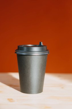 coffee to go. black glass for coffee on a table on a red background 