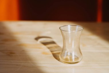 Turkish glass bowl on the table backlit by the sun.