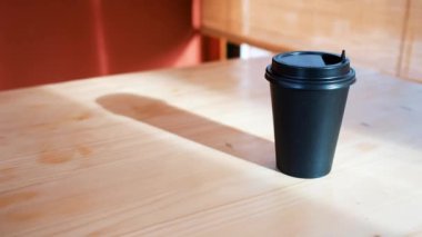 coffee to go. black glass for coffee on a table on a red background 