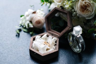 bridal bouquet, boutonniere, rings in a casket, perfume.