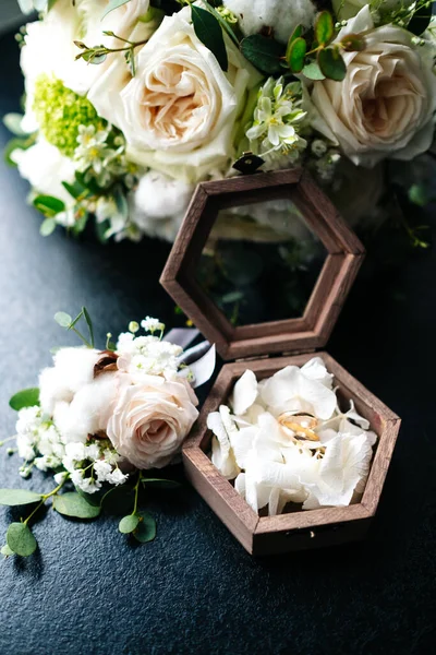 bridal bouquet, boutonniere, rings in a casket, perfume.