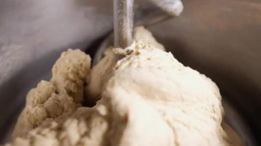 mixer mixes eggs with flour in a factory