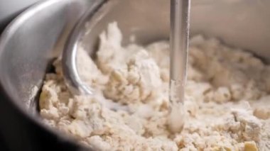 mixer mixes eggs with flour in a factory