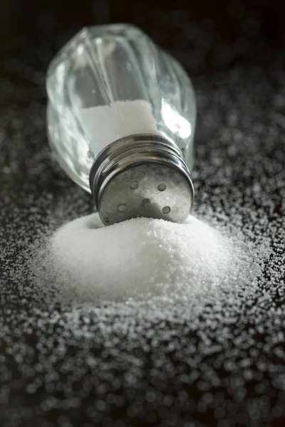 Salt shaker on pile of salt — Stock Photo, Image