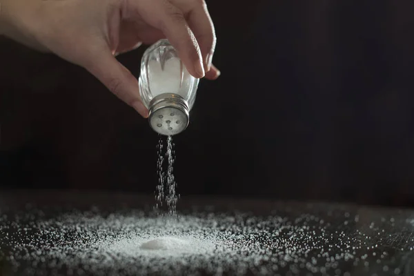 Backlight to salt from salt shaker. — Stock Photo, Image