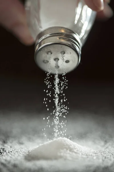 Backlight to salt from salt shaker. — Stock Photo, Image