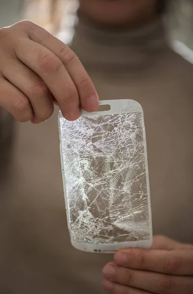 Mãos segurando uma tela quebrada do smartphone — Fotografia de Stock