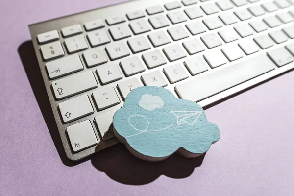 Cloud figure and keyboard on violet