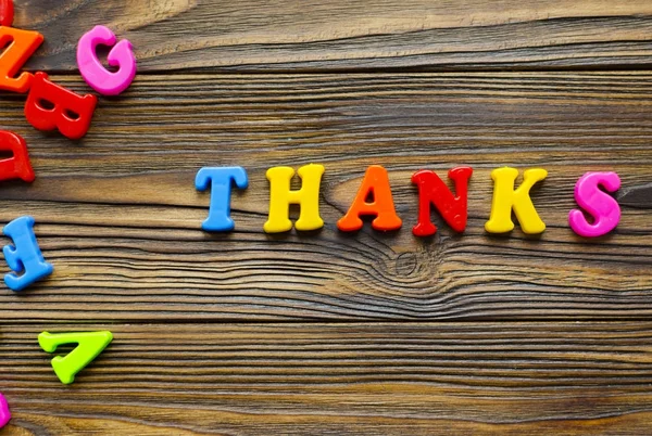 Colored text "Thank you" on wooden background — Stock Photo, Image