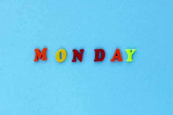 Word "monday" of plastic magnetic letters on blue background — Stock Photo, Image