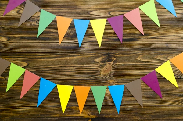 paper  flags  party garland  on wooden background