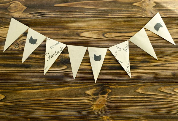 craft paper  flags  party garland  on wooden background