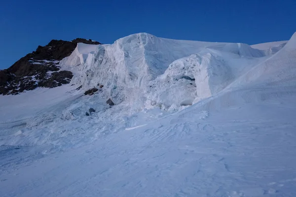 Big snow pack with glacier crevasse on Mont-blanc du Tacul in the French Alps, Chamonix-Mont-Blanc, France